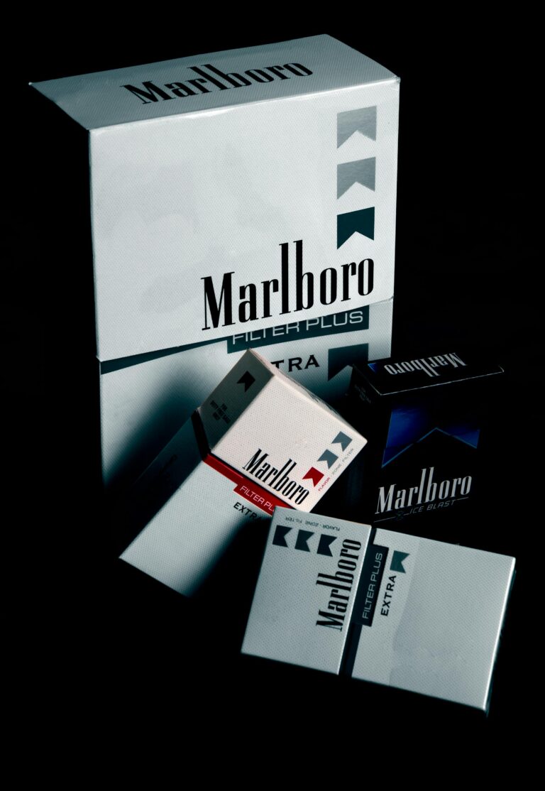 Collection of Marlboro cigarette packs displayed on a black surface, highlighting brand design.