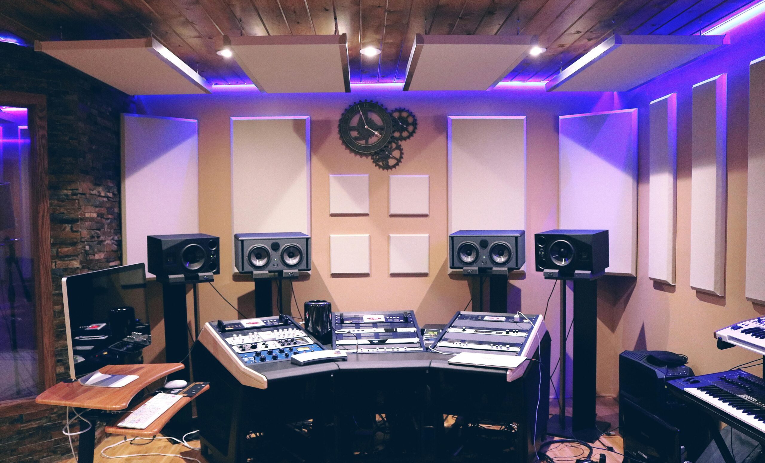 Modern recording studio with high-tech audio equipment and stylish lighting.